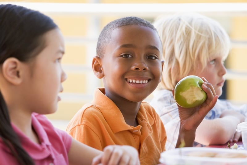 Pack fruits and vegetables in your kids' lunches to promote a healthy smile.