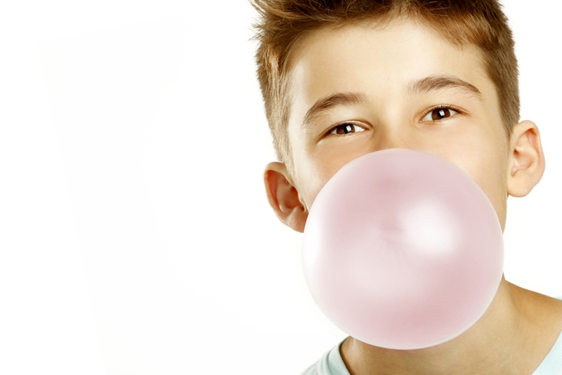 The sugar in gum can react with plaque to create acid.