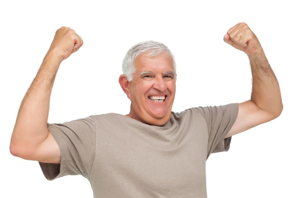 Senior Dental Care - Cheerful senior man with fists clenched in victory