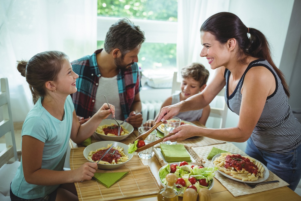 Family eating healthy foods that have positive effects on oral health