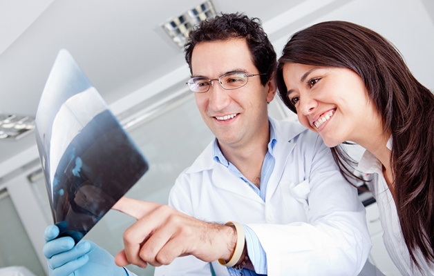 Dentist looking at an x-ray with a patient