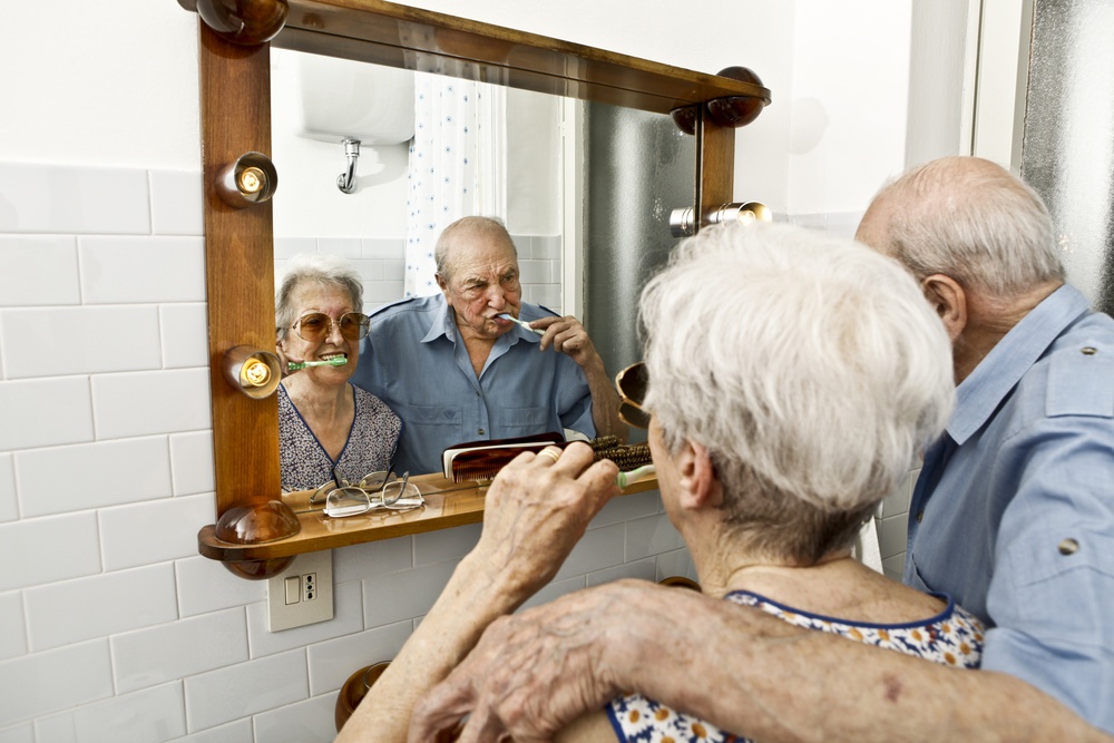 Senior couple brushing teeth